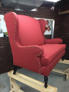 Wingback settee with decorative domed brass nails