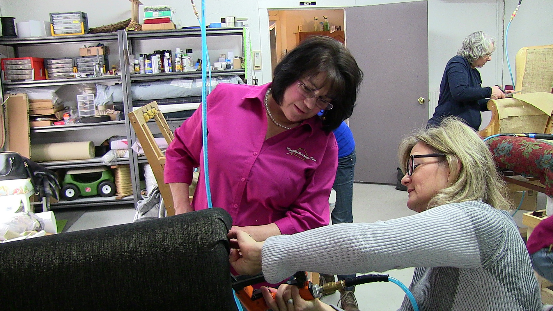 Kim helping a member learn upholstery