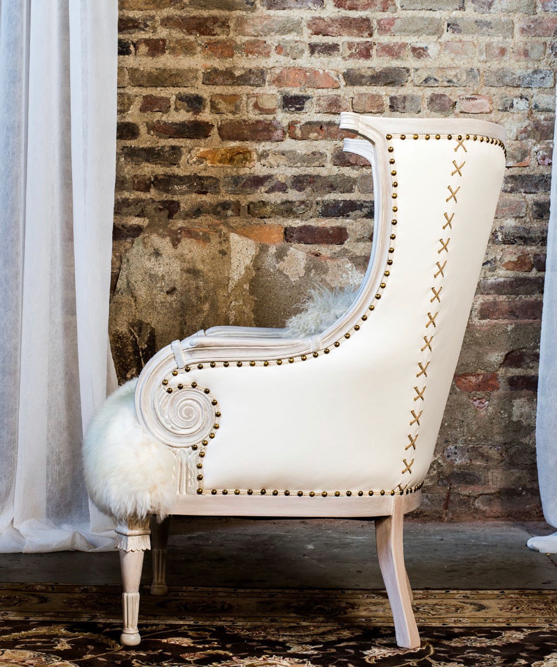 white upholstered chair with gold embellishments